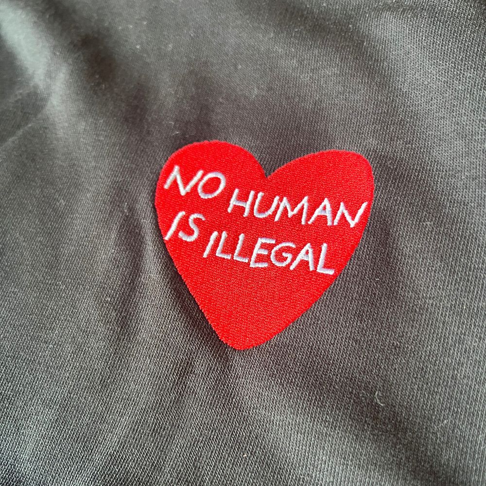 No Human Is Illegal Embroidered Organic Hoodie